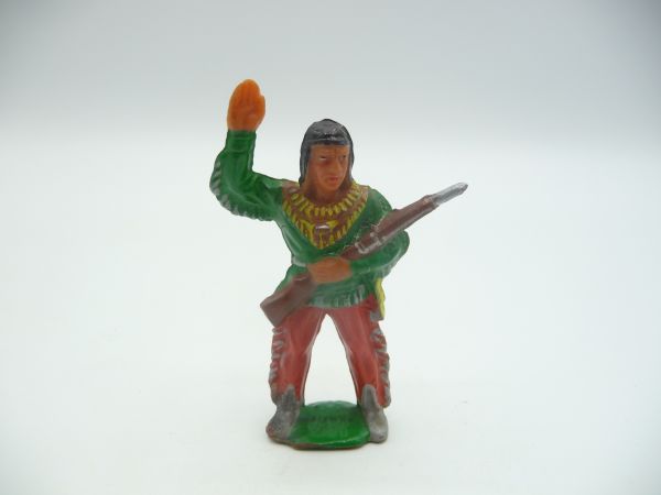 Winnetou standing with silver rifle, green shirt, red trousers