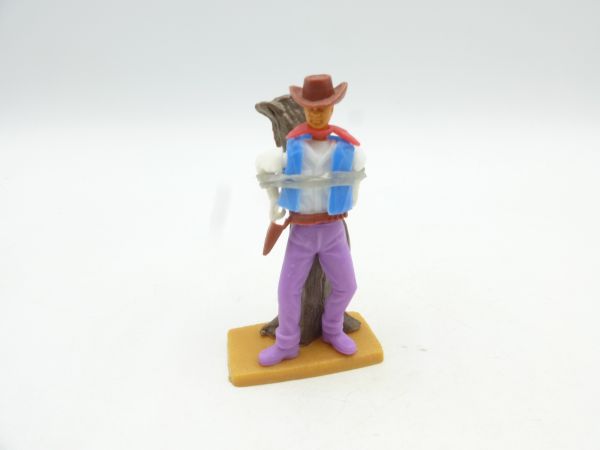 Plasty Cowboy tied to a stake