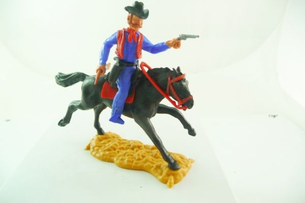Timpo Toys Cowboy 4. Version reitend, dunkelblaues Hemd, rote Weste