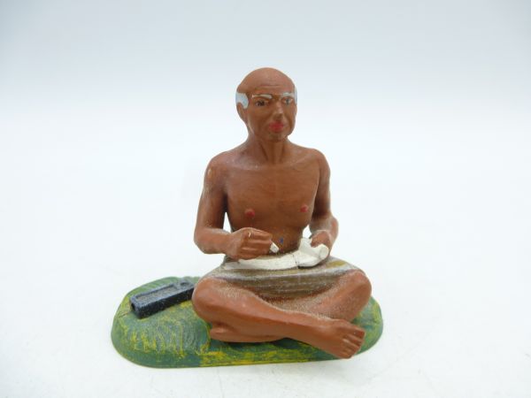 Indian scholar sitting cross-legged, writing