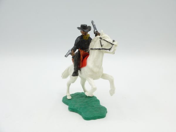 Timpo Toys Cowboy reitend mit 2 Pistolen wild schießend