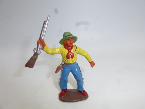 Cowboy standing, holding up rifle (7 cm size)