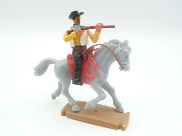 Plasty Cowboy riding, firing, with loose rifle