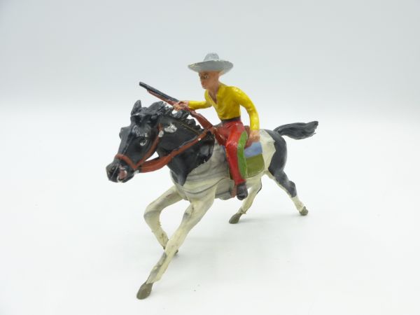 Merten Cowboy riding, rifle on his hip - great horse