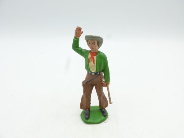 Cowboy standing with rifle, hand raised in salute