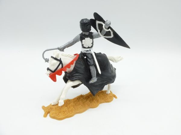 Timpo Toys Mittelalterritter reitend schwarze mit Blume, seitlich schlagend