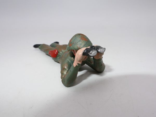 Soldier (camouflage uniform) lying down with binoculars