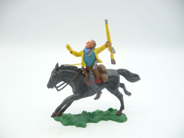 Britains Swoppets Cowboy riding with rifle, hit by arrow, jacket yellow