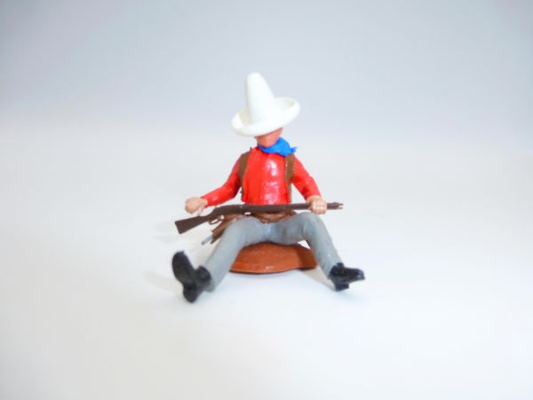 Britains Swoppets Cowboy sitting at a tree trunk with rifle