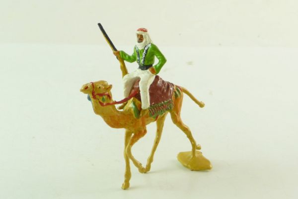 Merten Arab riding on camel with rifle at hip