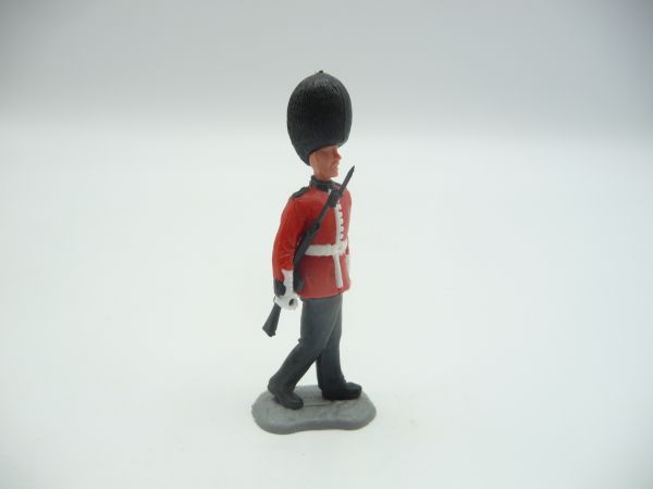 Timpo Toys Guardsman marching, rifle sideways at arm