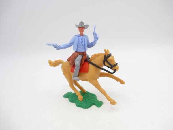 Timpo Toys Cowboy 1. Version (kleiner Hut) reitend, 2 Pistolen schießend