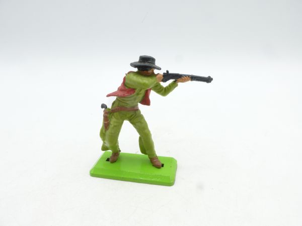 Britains Deetail Cowboy standing, shooting sideways, lime green/red