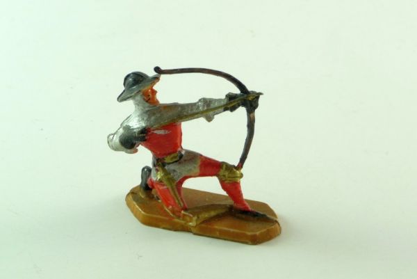 Merten Knight kneeling, shooting with bow