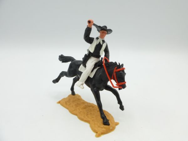Timpo Toys Cowboy 2. Version reitend mit schwarzem original Gewehr schlagend