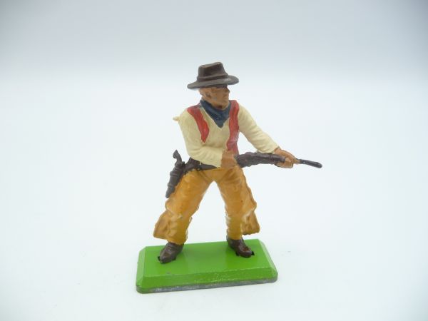 Britains Deetail Cowboy firing rifle from the hip, beige/brown