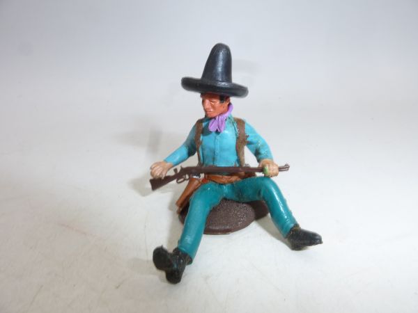 Britains Swoppets Cowboy sitting on tree trunk, black Stetson