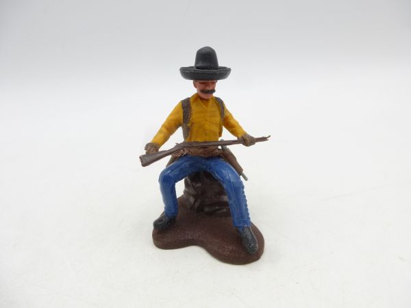 Britains Swoppets Cowboy auf Stein sitzend mit Gewehr